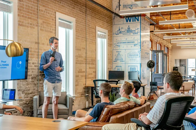 Colleagues gathered for a relaxed business conversation in a bright office