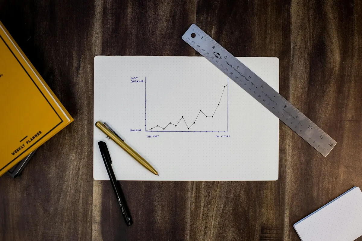 A hand-drawn growth chart on paper with a pen and ruler